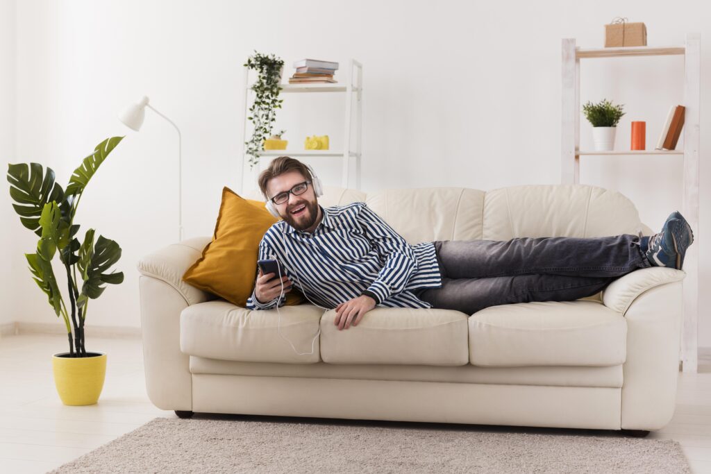 smiley-man-sofa-enjoying-music